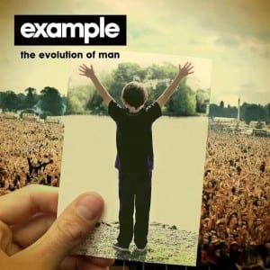 This image shows Example's album cover, which is of him holding a photo of himself as a child, whilst facing a huge crowd of people